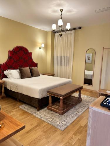 a bedroom with a large bed and a table at Blerina's Agritourism Concept in Laknas