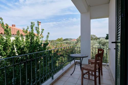 a balcony with two chairs and a table and a view at Art Lesvos Villa in Pyrgi Thermis
