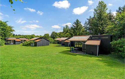 a row of huts in a field of grass at 1 Bedroom Gorgeous Home In Hampen in Hampen
