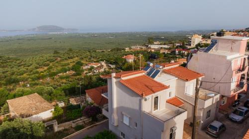an aerial view of a white house with red roofs at Panorama Sea View Residence in Gargaliánoi