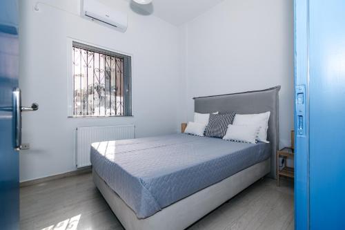 a bedroom with a bed in a white room at Panorama Sea View Residence in Gargaliánoi