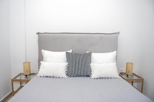 a bed with two night stands and two pillows at Panorama Sea View Residence in Gargaliánoi
