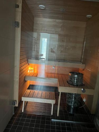 a sauna with two benches and a table and a pot at Stylish spacious apartment in Tuusula in Hyrylä