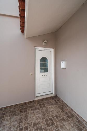 a room with a white door and a tile floor at Panorama Sea View Residence in Gargaliánoi