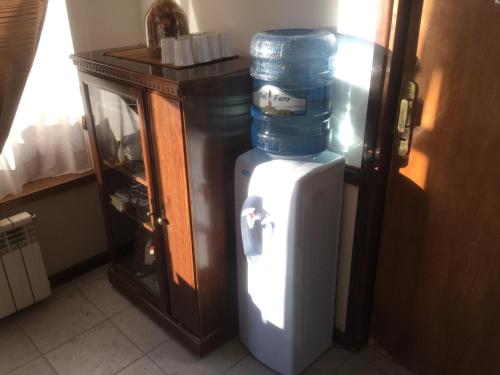 een stapel blauwe vaten bovenop een koelkast bij Hosteria Sloggett in Ushuaia