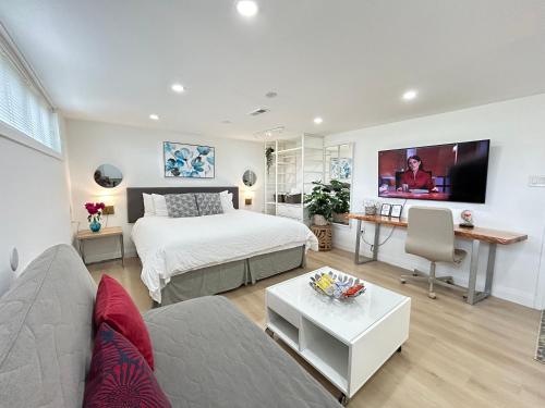 a bedroom with a bed and a living room at Modern Lux Family Rooms - KingBed - Near Sheppard W Station Toronto in Toronto