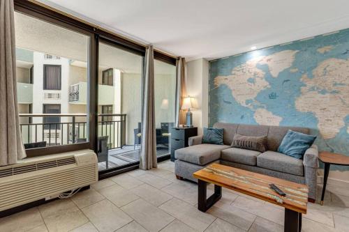 a living room with a couch and a map on the wall at Remodeled Oceanview Suite, Small Dogs OK 1738 in Myrtle Beach