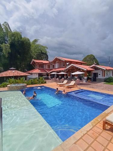a group of people in the swimming pool at a resort at Finca Hotel Santana in Montenegro