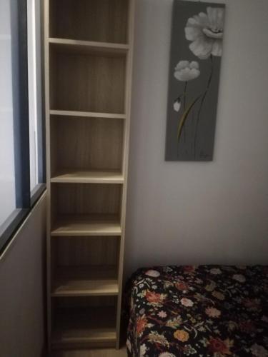 - une chambre avec une étagère à côté d'un lit dans l'établissement Appartement au coeur de la citadelle, à Bastia