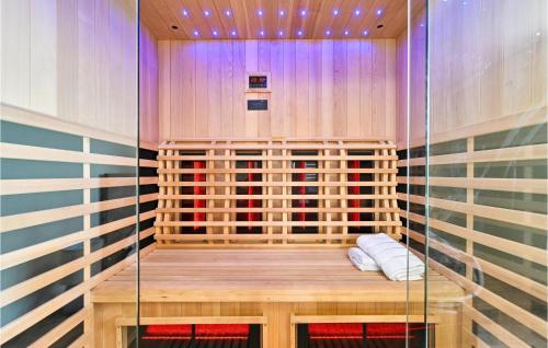 a sauna with a wooden floor and a glass wall at Amazing Home In Vinica Breg With Wifi in Gorušenjak