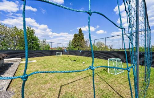 a batting cage with a soccer goal in a field at Amazing Home In Vinica Breg With Wifi in Gorušenjak