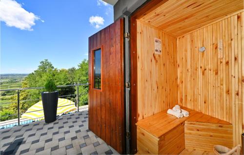 a wooden sauna with a bench on a deck at Stunning Home In Andrasevec With Sauna in Andraševec