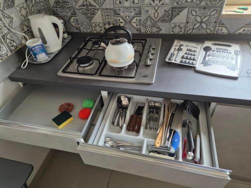 a cabinet with a stove top in a kitchen at Centrally located one floor in Paola