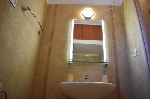 a bathroom with a sink and a mirror at IKIES LUXURY MAISONETTE HALKIDIKI Psakoudia in Psakoudia