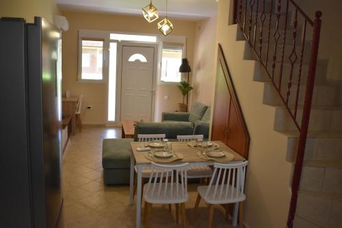 a dining table and chairs in a living room at IKIES LUXURY MAISONETTE HALKIDIKI Psakoudia in Psakoudia