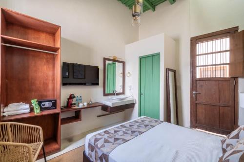 a bedroom with a bed and a sink and a mirror at Hotel Boutique Santa Elena in Mérida