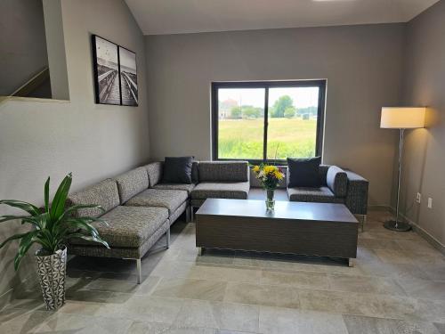 a living room with a couch and a coffee table at Wingate by Wyndham Salisbury in Salisbury