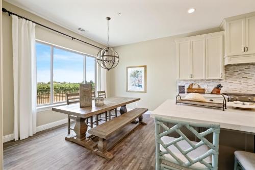 a kitchen with a table and a bench in front of a window at Artigas in Lodi