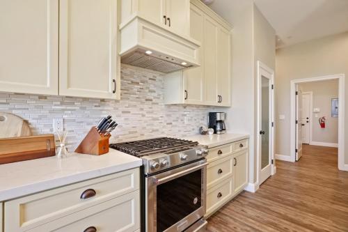 a kitchen with white cabinets and a stove top oven at Artigas in Lodi