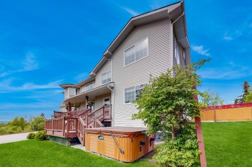 an apartment building with a deck and a yard at Alaska Sundance Retreat in Anchorage