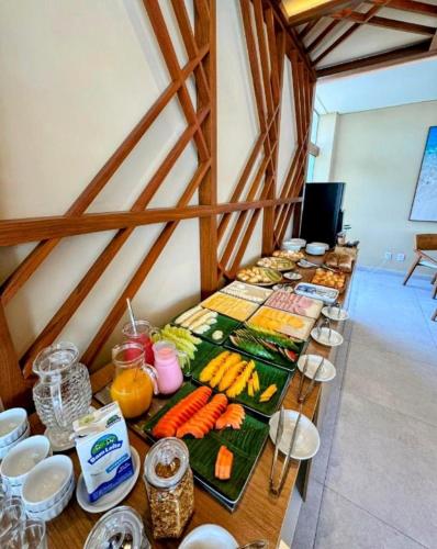 a long table filled with food in a room at Makia Beach Experience By All in Porto De Galinhas