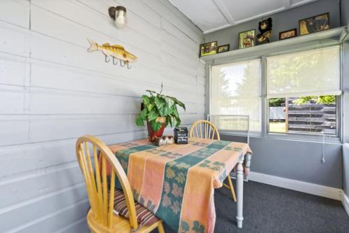 a dining room with a table and chairs at Cheerful Cottage Close to Franconia Notch #4 in Carroll