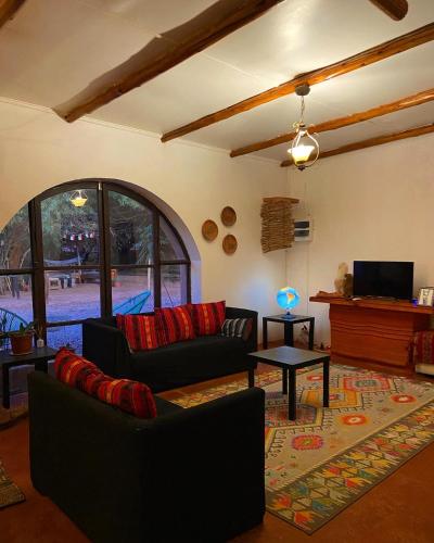 a living room with a couch and a table at CaminAndes Hostal in San Pedro de Atacama