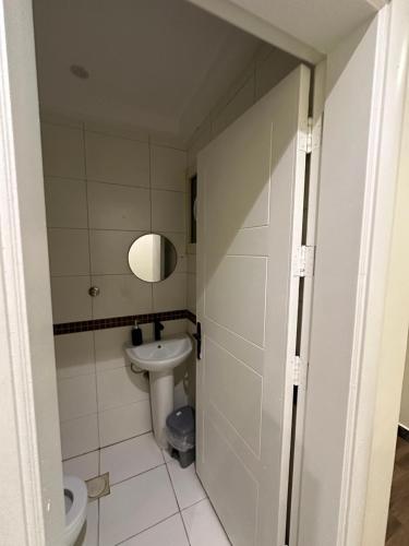 a small bathroom with a toilet and a sink at Studio with smart entry in Riyadh