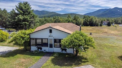 a house with two goats standing outside of it at Cheerful Cottage Close to Franconia Notch #4 in Carroll