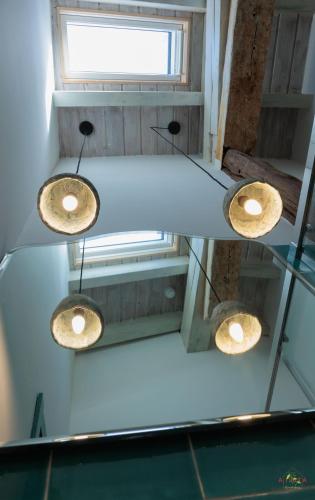 two lights hanging from the ceiling in a room at AISTA Landetxea in Campanchu