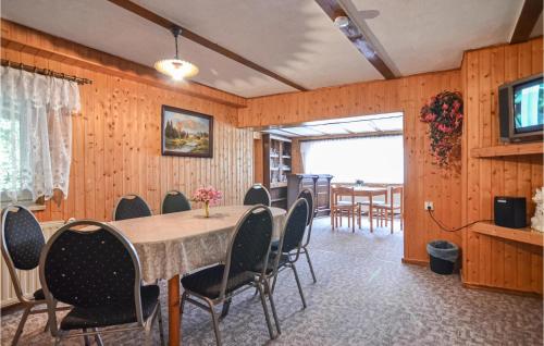 a dining room with a table and chairs at Lovely Home In Heideblick With Kitchen in Langengrassau