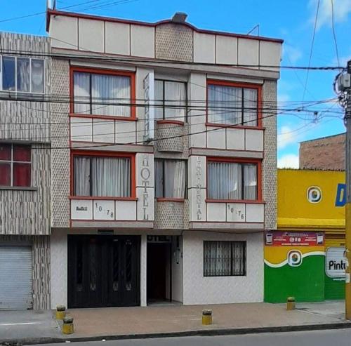 an apartment building with windows on a city street at Hotel continental del sur in Pasto
