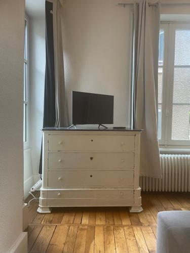 - une commode avec une télévision dans une pièce dans l'établissement Appartement Centre Historique de Montluçon, à Montluçon