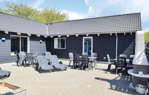 a patio with a bunch of chairs and tables at Holiday Home Kronens Have Tranekær X in Hou