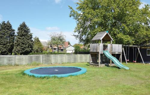 a small playground with a slide and a play structure at Holiday Home Kronens Have Tranekær X in Hou