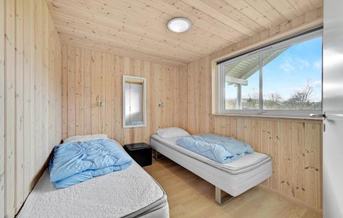 two beds in a room with a window at Holiday Home Kronens Have Tranekær X in Hou