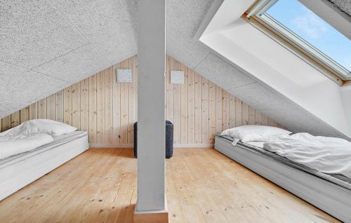 two beds in a room with a attic at Holiday Home Kronens Have Tranekær X in Hou