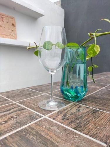 a wine glass and a vase on a counter at Casa Bambú in Mérida