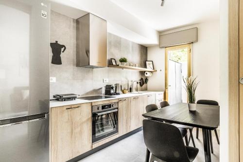 a kitchen with a table and a dining room at GRADO HOUSE-Garden & Hydromassage-Sea-Free Parking in Grado
