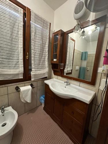 a bathroom with a sink and a toilet and a mirror at La Cascina della Vachina in Poggio Bustone