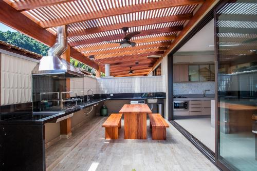 a large kitchen with a wooden table and benches at Residencial Marina Del Sol in Pauba