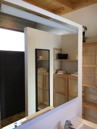 a mirror over a sink in a bathroom at CA'MALÚ Estudio en el mar in Arrieta