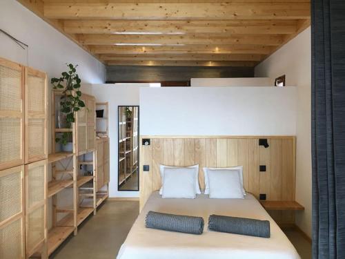 a bedroom with a large bed with wooden walls at CA'MALÚ Estudio en el mar in Arrieta