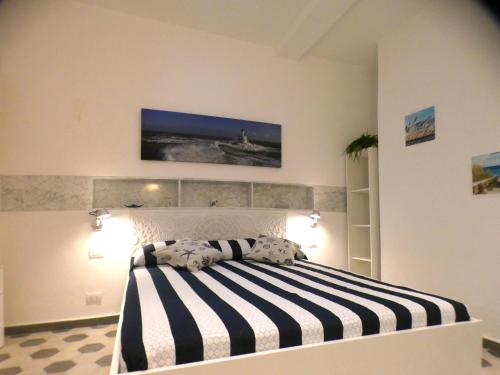 a bedroom with a black and white striped bed at Il Piccolo Convento- NUOVA GESTIONE 2025- in La Spezia