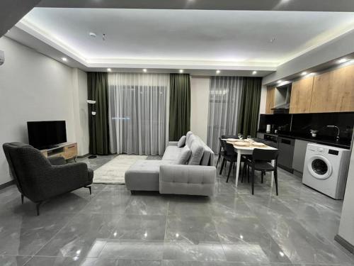 a living room with a couch and a table at Silence garden in Alanya