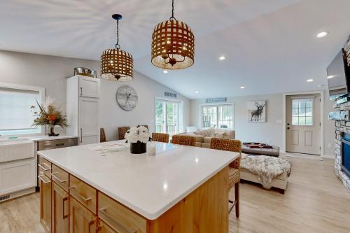 a kitchen and living room with a table and a couch at Two Bit Cabin in Deadwood