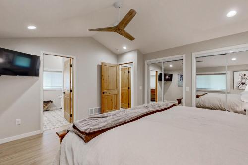 a bedroom with a large bed and a ceiling fan at Two Bit Cabin in Deadwood