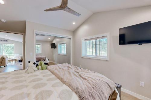 a bedroom with a bed and a flat screen tv at Two Bit Cabin in Deadwood
