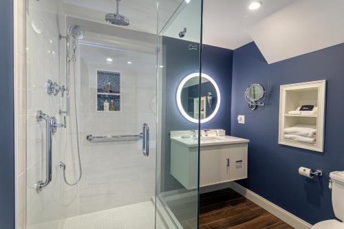 a bathroom with a glass shower and a toilet at The West Lane Inn in Ridgefield