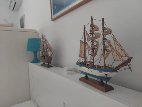 a model of a boat sitting on top of a shelf at Blue Sea Apartment in Torre Canne